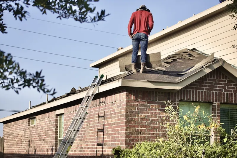 Professional roofer working on a residential roof in Stone Harbor Manor